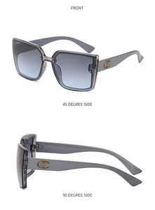 Détail de lunettes de soleil carrées oversize avec verres dégradés et décorations de branche G