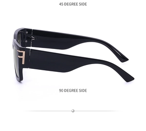 Detail view of large square sunglasses showing gold T-shaped metal hinges on thick black frames