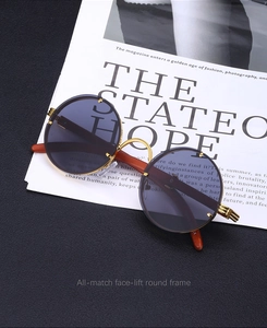 Detail of vintage round sunglasses with wood grain temples on a stylish magazine