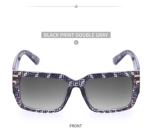 Close-up of square sunglasses with black monogram frame and gradient gray lenses