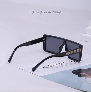 Detail view of large square sunglasses featuring gold chain accents and size markings