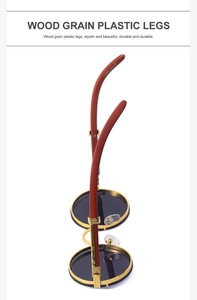 Detail of round vintage sunglasses with gold metal frame and red-brown wood grain temples