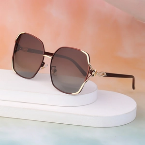 Women's oversized polarized sunglasses with golden frame and rhinestone temple accents