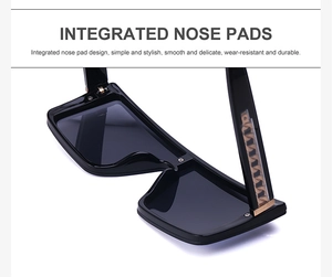 Close-up of integrated nose pads on black oversized square sunglasses with metal trim