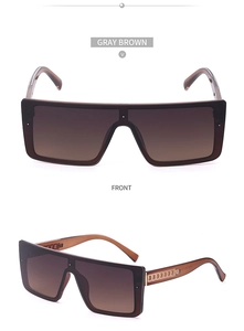 Detail of gray brown flat top oversized sunglasses with chain-textured temples