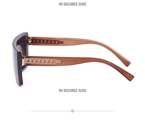 Detail view of large frame sunglasses with distinctive golden metal chain on temples
