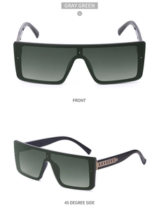 Detail view of oversized gray green shield sunglasses with golden chain temples