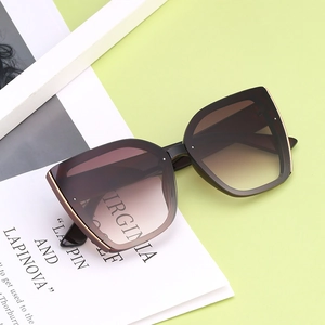 Fashionable oversized cat-eye sunglasses with gradient lenses and gold metal trim decor