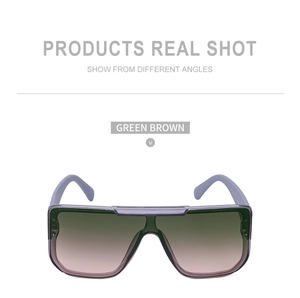 Close-up of oversized oversized sunglasses with light purple frames and green brown lenses