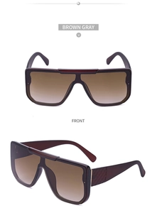 Detail of stylish oversized gradient brown sunglasses featuring diamond-patterned temples