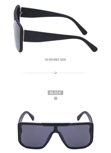 Detail view showing black shield sunglasses with textured temples and UV protection lenses