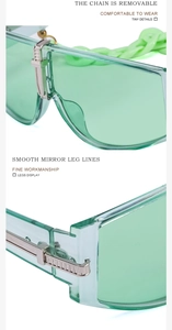 Macro shot of light green resin sunglasses showing removable chain and smooth metal hinges