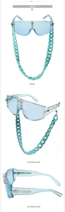 Detail view of light blue oversized sunglasses with gold accents and a matching chunky chain