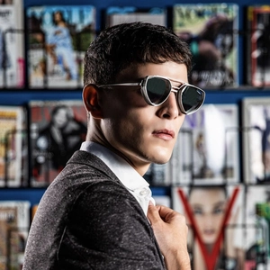 Close-up of men's steampunk sunglasses with hollow silver metal frame and dark lenses