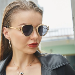 Detail view of steampunk sunglasses with golden hollow-out frame and dark polarized lenses