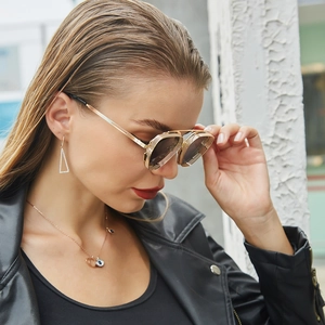Detail of steampunk sunglasses with side metal mesh shields and vintage golden frame