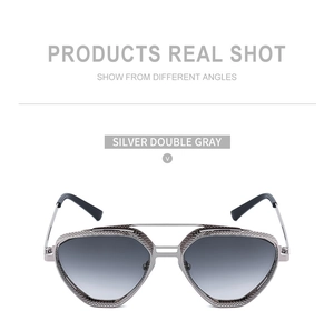Detail of silver steampunk sunglasses with intricate metal mesh cutouts and gray lenses