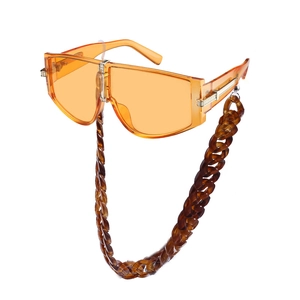 Oversize orange sunglasses with amber chunky chain strap and gold temple accents