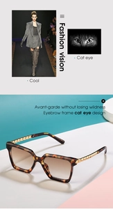 Detail of tortoise cat-eye sunglasses with golden twisted metal temples and tinted lenses