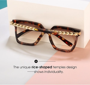 Detail of tortoise square sunglasses with golden V-shaped textured metal temples