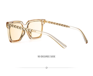Side view of square sunglasses featuring yellow lenses and golden woven metal temples
