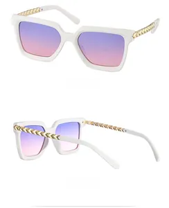 Detail of white square frame sunglasses with gradient lenses and gold temple accents