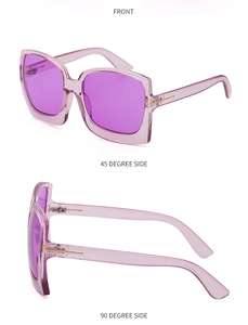 Detailansicht der lila Oversize-Sonnenbrille mit markanten goldenen T-Scharnieren am Bügel