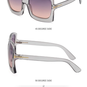 Detailansicht der Oversize-Sonnenbrille mit Verlaufsgläsern und goldenen T-Metallscharnieren