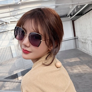 Detail of oversized metal frame sunglasses with purple gradient lenses on model