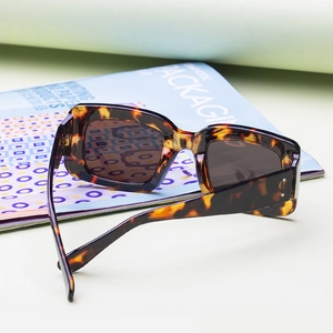 Vintage tortoiseshell square sunglasses with dark lenses and silver stud details