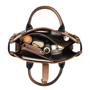 Spacious interior of a canvas and leather tote bag showing organized multi-layer compartments