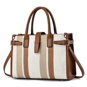 Minimalist canvas tote bag with brown leather trim and striped design in a frontal view
