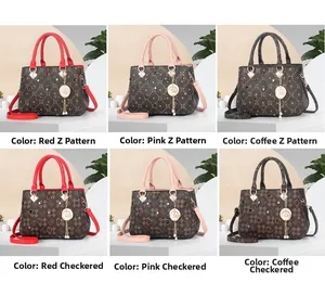 Detail of vintage printed crossbody bag with star charm and contrast grid pattern
