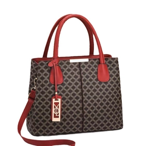 Women's tote bag with dark coffee monogram and red leather handles in a 45-degree angle view