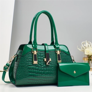 Close-up of green crocodile embossed patent leather tote bag with matching coin purse