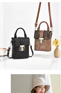 Close-up of vintage mini phone bags with woven texture and monogram print detailing