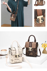 Detail of mini crossbody phone bag with graffiti print and gold buckle closure