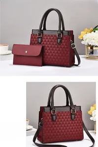 Close-up of wine red tote bag set with triangle pattern and brown faux leather straps