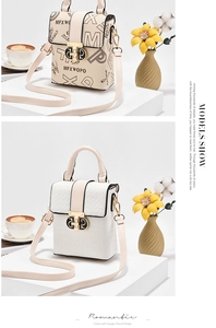 Detail of minimalist printed crossbody bag with gold metal clasp and textured pattern