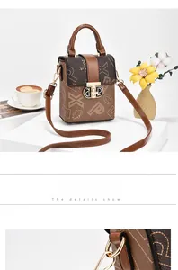 Detail of vintage monogram leather crossbody phone bag with metal clasp and scenery