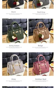 Close-up of litchi grain leather handbags with plush ball charms in various colors