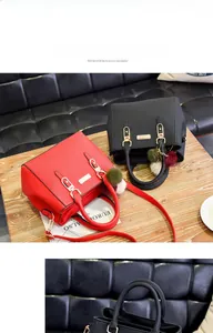 Detail view of leather crossbody bags with metal handles and decorative fur balls on a table