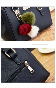 Detail of lychee textured leather bag with tricolor pompom charm and golden zipper