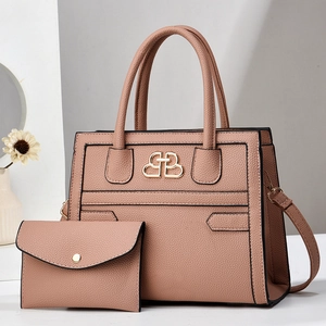 Détail de l'ensemble sac cabas et pochette en cuir grainé rose poudré avec logo doré