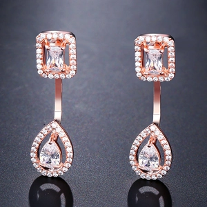 Detailed view of rose gold geometric drop earrings with sparkling zircon crystals