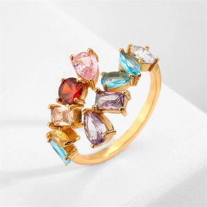 Irregular gold ring featuring multi-colored cubic zirconia in various geometric cuts