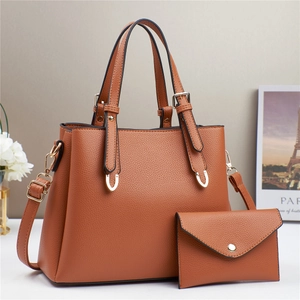 Brown litchi grain tote bag and matching clutch set with golden hardware details