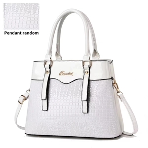 White faux crocodile leather handbag with glossy texture and adjustable shoulder strap