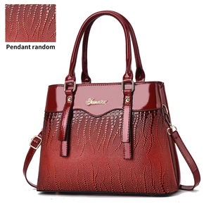 Deep red patent leather tote bag with lizard texture stitching and golden hardware