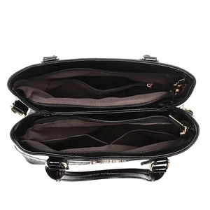 Top view of large black patent leather handbag featuring multi-compartment interior storage